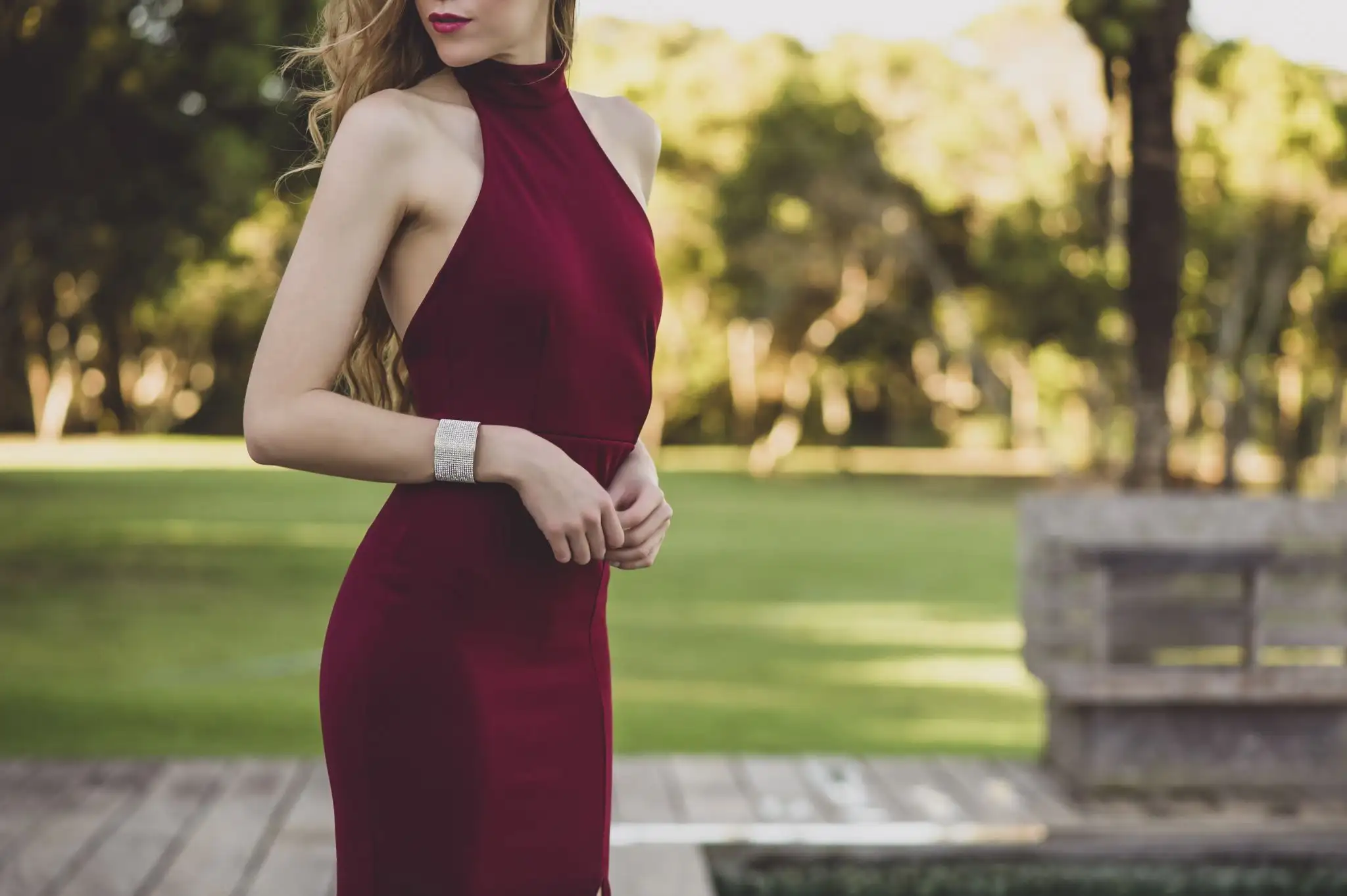 High-class Vienna escort in an elegant burgundy evening dress